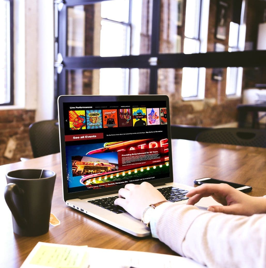 person at a coffee shop scrolling through a stunning website design from a company in spring hill tn near brentwood